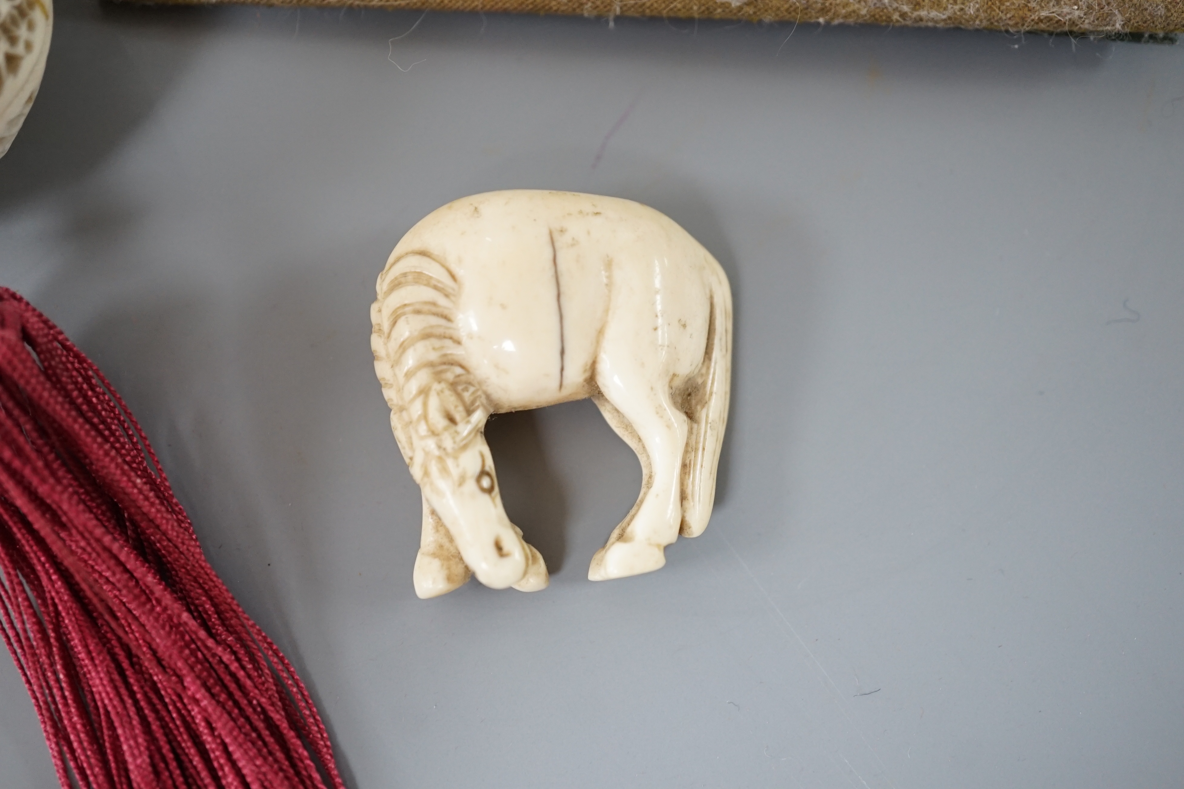A 19th century Chinese pierced Ivory scent box together with a netsuke modelled as a horse and ivory pierced panel (3)